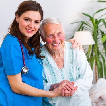 Happy Senior Woman Laying In Bed In A Well Equipped